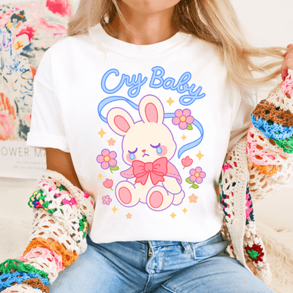 White Kawaii Coquette T-shirt with cute bunny and 'Cry Baby' text, styled with colorful crochet cardigan for a soft girl aesthetic outfit.