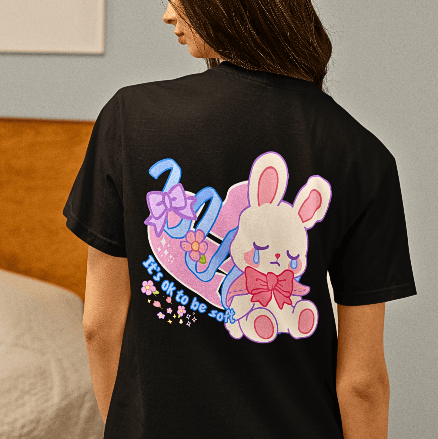 Back view of black Kawaii Coquette T-shirt showing a sad bunny with bows and 'It's ok to be soft' text, ideal for Y2K and pastel fashion lovers.